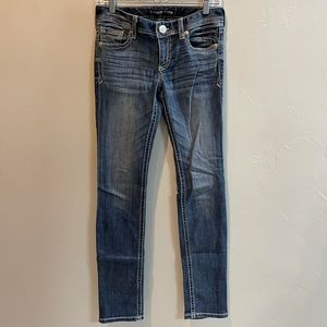 Women’s Express skinny low rise medium wash jean with accent stitching.
